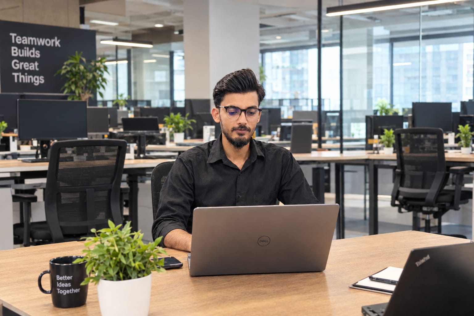 Muhammad Owais working on his laptop in an office